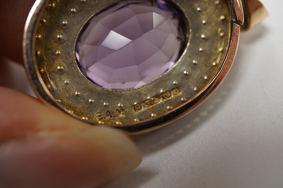 An Edwardian 9ct gold, amethyst and seed pearl cluster set oval pendant, Edwin Alfred Marsh, Birmingham, 1903, overall 35mm.